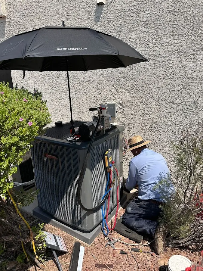 HVAC technician performing outdoor AC maintenance in Chanhassen
