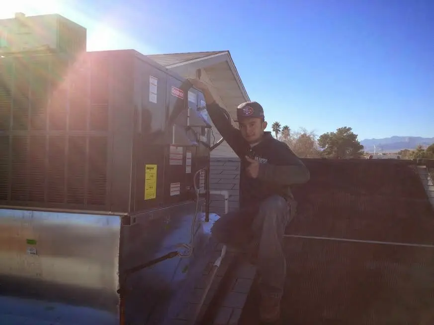 HVAC technician performing HVAC Inspection on a rooftop unit in Chanhassen